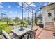 Relax or entertain in this screened patio area, complete with a dining set and views of the lush backyard at 11339 Alden Ct, Hudson, FL 34667