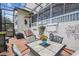 Enjoy the spacious screened patio, complete with an outdoor table and lush landscaping for serene outdoor living at 11339 Alden Ct, Hudson, FL 34667
