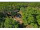 Birds-eye view reveals a cozy home surrounded by thick, green forest canopy at 11423 Ennis Sheard Rd, Seffner, FL 33584
