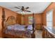 Bright bedroom features a wooden bed frame, wooden floor, side table and closet at 1147 Monroe Ave, Brooksville, FL 34604