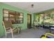 Comfortable porch area featuring textured walls, a patterned front door and a cozy seating arrangement with rocking chairs at 1147 Monroe Ave, Brooksville, FL 34604
