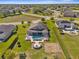 Aerial view showcasing a backyard oasis with pool, pergola, fire pit, and meticulously landscaped yard at 1155 Buckhurst Dr, Spring Hill, FL 34609