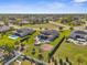 Expansive aerial view showcases three homes each with swimming pools and spacious landscaped yards at 1155 Buckhurst Dr, Spring Hill, FL 34609