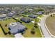 Expansive aerial view of a neighborhood featuring well-manicured lawns and luxurious homes with pools at 1155 Buckhurst Dr, Spring Hill, FL 34609