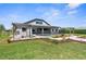 View of backyard with lush lawn, garden, covered patio and fenced pool at 1155 Buckhurst Dr, Spring Hill, FL 34609