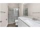 Bathroom featuring tiled shower, white vanity with marbled countertop, and tile flooring at 1155 Buckhurst Dr, Spring Hill, FL 34609