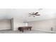 Large bonus room featuring carpet flooring, billiard table, ceiling fan, and a bright window at 1155 Buckhurst Dr, Spring Hill, FL 34609