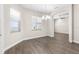 Bright dining area with wood-look flooring, natural light from windows, and decorative chandelier at 1155 Buckhurst Dr, Spring Hill, FL 34609