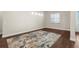 Dining room boasts wood floors, natural light from a window, and a contemporary light fixture at 1155 Buckhurst Dr, Spring Hill, FL 34609
