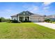 Charming single-Gathering home with well-manicured lawn, three-car garage, and neutral color scheme at 1155 Buckhurst Dr, Spring Hill, FL 34609