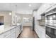 Modern kitchen with stainless steel appliances, a center island, and bright white cabinetry at 1155 Buckhurst Dr, Spring Hill, FL 34609