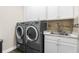 Laundry room with front load washer and dryer, sink and cabinets at 1155 Buckhurst Dr, Spring Hill, FL 34609