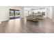 Open-concept living room showcases modern flooring, access to the patio, and a view into the kitchen at 1155 Buckhurst Dr, Spring Hill, FL 34609