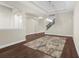 Bright living room showcases wood floors, arched entryways, and a staircase with a modern light fixture at 1155 Buckhurst Dr, Spring Hill, FL 34609