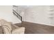 Spacious living room with hardwood floors, stairs to the second floor, and recessed lighting at 1155 Buckhurst Dr, Spring Hill, FL 34609