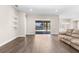 Open living room showcasing hardwood floors and outdoor patio access at 1155 Buckhurst Dr, Spring Hill, FL 34609