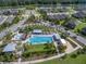 This aerial view showcases a community pool with lounge chairs, seating, and lush landscaping at 12266 Barn Cat Run, Odessa, FL 33556