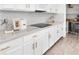 Contemporary kitchen showcasing white cabinets, gray backsplash, and modern appliances at 12266 Barn Cat Run, Odessa, FL 33556