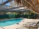 Relax by the pool under the shaded lanai with comfortable loungers, perfect for enjoying the Florida sun at 12330 Comstock St, Spring Hill, FL 34609