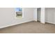 Bedroom with large window and closet, offering a view of the outdoors at 12450 Fish Cove Dr, Spring Hill, FL 34609