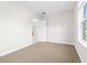 Neutral bedroom with ample natural light and a doorway to an adjacent room at 12450 Fish Cove Dr, Spring Hill, FL 34609