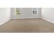 Bright bedroom with two windows and neutral carpet, perfect for relaxation at 12450 Fish Cove Dr, Spring Hill, FL 34609