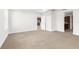 Spacious bedroom with views to kitchen area and carpeted flooring at 12450 Fish Cove Dr, Spring Hill, FL 34609