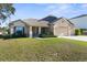 Lovely one-story residence with a three-car garage, attractive landscaping, and a welcoming entrance at 12450 Fish Cove Dr, Spring Hill, FL 34609