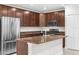 Spacious kitchen featuring stainless steel appliances and dark wood cabinetry at 12450 Fish Cove Dr, Spring Hill, FL 34609