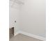 Tile-floored laundry room featuring hookups and shelving at 12450 Fish Cove Dr, Spring Hill, FL 34609