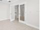 Open living space with tile flooring and glass paneled doors providing a view to other rooms of the house at 12450 Fish Cove Dr, Spring Hill, FL 34609