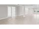 Spacious living area with tile floors, recessed lights, and access to other rooms through glass paneled doors at 12450 Fish Cove Dr, Spring Hill, FL 34609