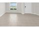 Bright and airy living room featuring neutral tile floors and plenty of natural light at 12450 Fish Cove Dr, Spring Hill, FL 34609