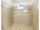 Tiled walk-in shower with glass enclosure and modern fixtures, a spa-like retreat at 12450 Fish Cove Dr, Spring Hill, FL 34609
