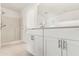 Bathroom showcases a vanity with white cabinets, modern hardware, and a spacious shower at 1313 Gatewood Ave, Spring Hill, FL 34608