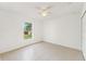 Well-lit bedroom featuring tile floors, a ceiling fan, and a spacious closet at 1313 Gatewood Ave, Spring Hill, FL 34608