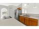Bright kitchen with stainless steel refrigerator, double basin sink, and ample countertop space at 1313 Gatewood Ave, Spring Hill, FL 34608