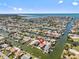 Aerial view of a waterfront neighborhood, featuring this home and its proximity to the water at 13820 Plumosa Ave, Hudson, FL 34667