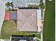 Aerial view of roof showing roof type, upper level deck, and backyard at 13820 Plumosa Ave, Hudson, FL 34667