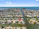 Aerial view of waterfront neighborhood featuring canal access to the Gulf, single Gathering homes, and sea breezes at 13820 Plumosa Ave, Hudson, FL 34667