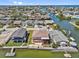 Aerial view of waterfront home with private boat docks and waterway access to gulf, and mature landscaping at 13820 Plumosa Ave, Hudson, FL 34667