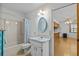 Bathroom with shower-tub combo, toilet, vanity with sink, and open view of kitchen at 13820 Plumosa Ave, Hudson, FL 34667