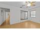 Bedroom featuring light hardwood floors, closet with sliding mirror doors, and built-in storage at 13820 Plumosa Ave, Hudson, FL 34667