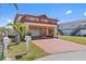 Charming two-story waterfront home with a two-car garage, balconies, and well-manicured lawn at 13820 Plumosa Ave, Hudson, FL 34667