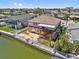 Waterfront two-story home featuring a backyard patio, fenced yard, mature landscaping and expansive balconies at 13820 Plumosa Ave, Hudson, FL 34667