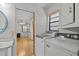 Laundry room with washer and dryer, window, and an open view to a bedroom at 13820 Plumosa Ave, Hudson, FL 34667