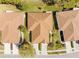 Bird's eye view of a home showcasing its brown roof, landscaping, and proximity to neighboring homes at 14471 Sterling Run, Spring Hill, FL 34609