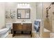 Bathroom featuring a vanity with storage, a walk-in shower with seating, and neutral tile at 14471 Sterling Run, Spring Hill, FL 34609