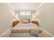 Inviting bedroom featuring a striped bed, dual nightstands with lamps, and natural light at 14471 Sterling Run, Spring Hill, FL 34609
