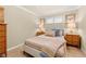 Cozy bedroom with a striped bedspread, wood furnishings, and a neutral color scheme at 14471 Sterling Run, Spring Hill, FL 34609